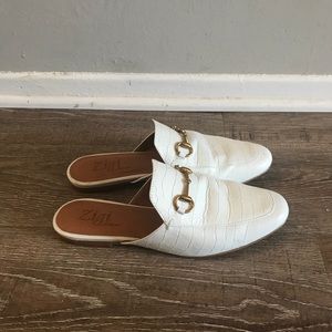 White leather closed toe mules with gold buckle